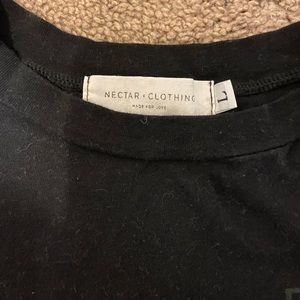 Black short (not cropped) T shirt. Says travel, super comfortable.